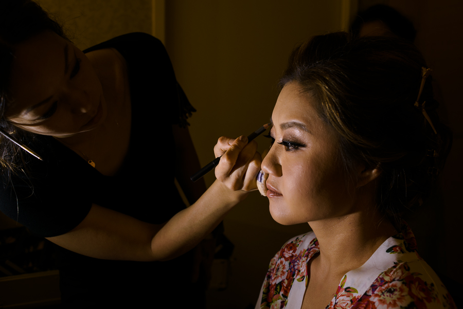 A dramatic black and white image of a bride getting ready