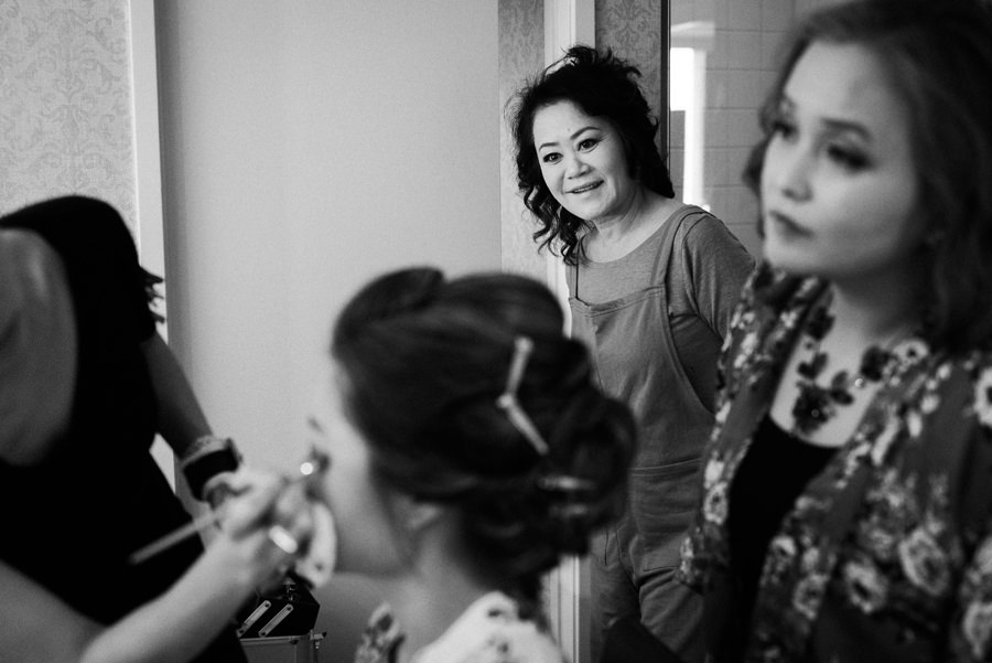 Image of a mom watching her daughter being made up for her Wedding