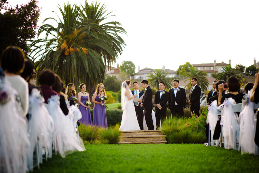 A view of Wedding in progress at Silver Creek Country Club with Palm trees in the background