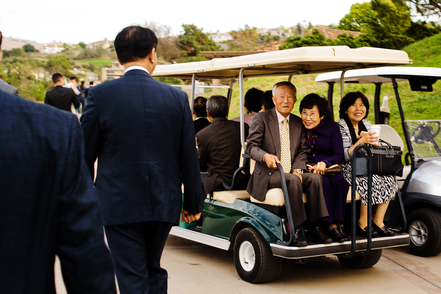 A picture of guests being transported on a golf cart